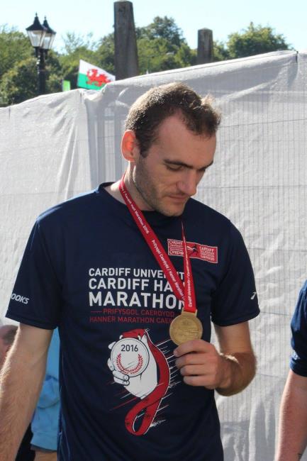 Proud moment for Tom as he is awarded his Cardiff Half Marathon medal